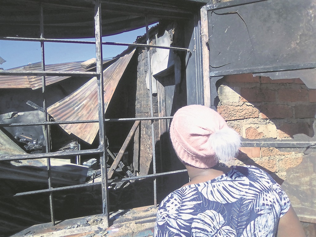 Nontozanele Motebele looks at the ruins of the room where her mum Manazo and Tshediso Mgxekwa were saved from a fiery death.  Photo by Kabelo Tlhabanelo.