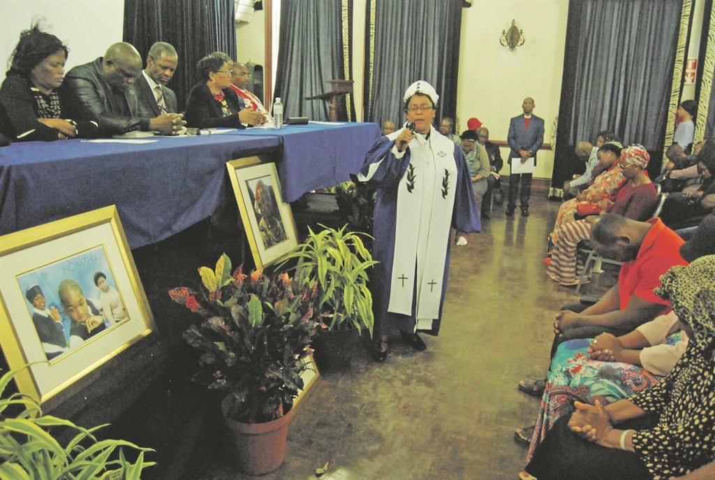 Bishop Duduzile Gumede from the Uthando Christian Church prays for bereaved families during a memorial service at the Durban City hall. Photo by Phumlani Thabethe