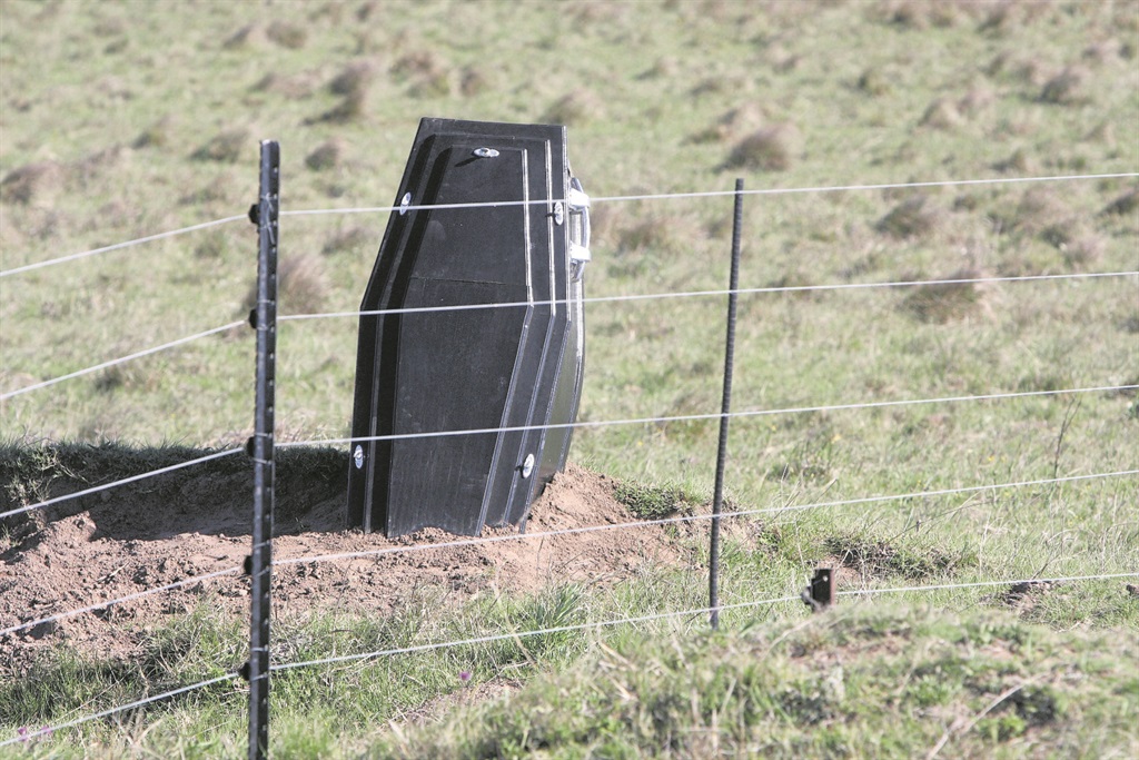 The half-buried black coffin on a farm in Stutterheim. Photo by Mbulelo Sisulu