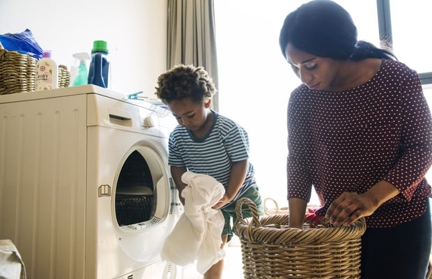 Mother and child doing laundry 