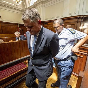 CAPE TOWN, SOUTH AFRICA â?? NOVEMBER 08: Jason Rohde is escorted to the cells by a police officer after being found guilty for the murder of his wife Susan Rohde at the Western Cape High Court on November 08, 2018 in Cape Town, South Africa. Judge Salie Hlophe found Rohde guilty of the 2016 murder his wife Susan and staging it as a suicide at Spier wine estate in Stellenbosch. The court was adjourned until 21 November for sentencing. (Photo by Gallo Images / Netwerk24 / Jaco Marais)