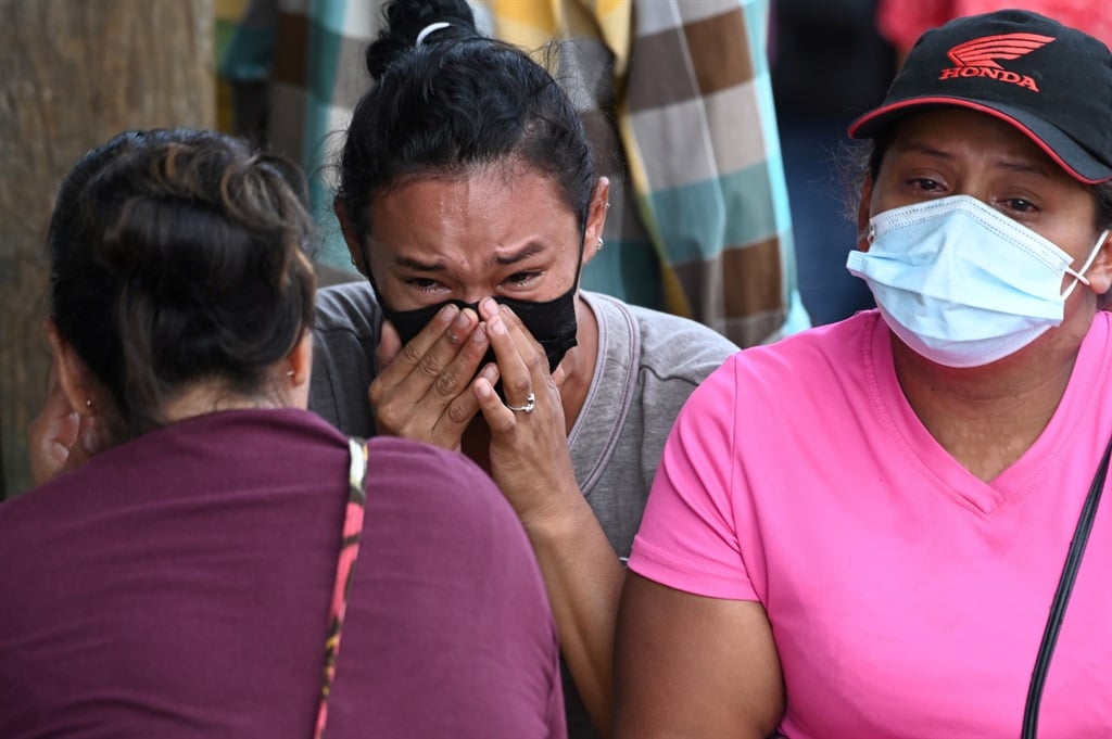 crying relatives outside a Honduras prison where 4