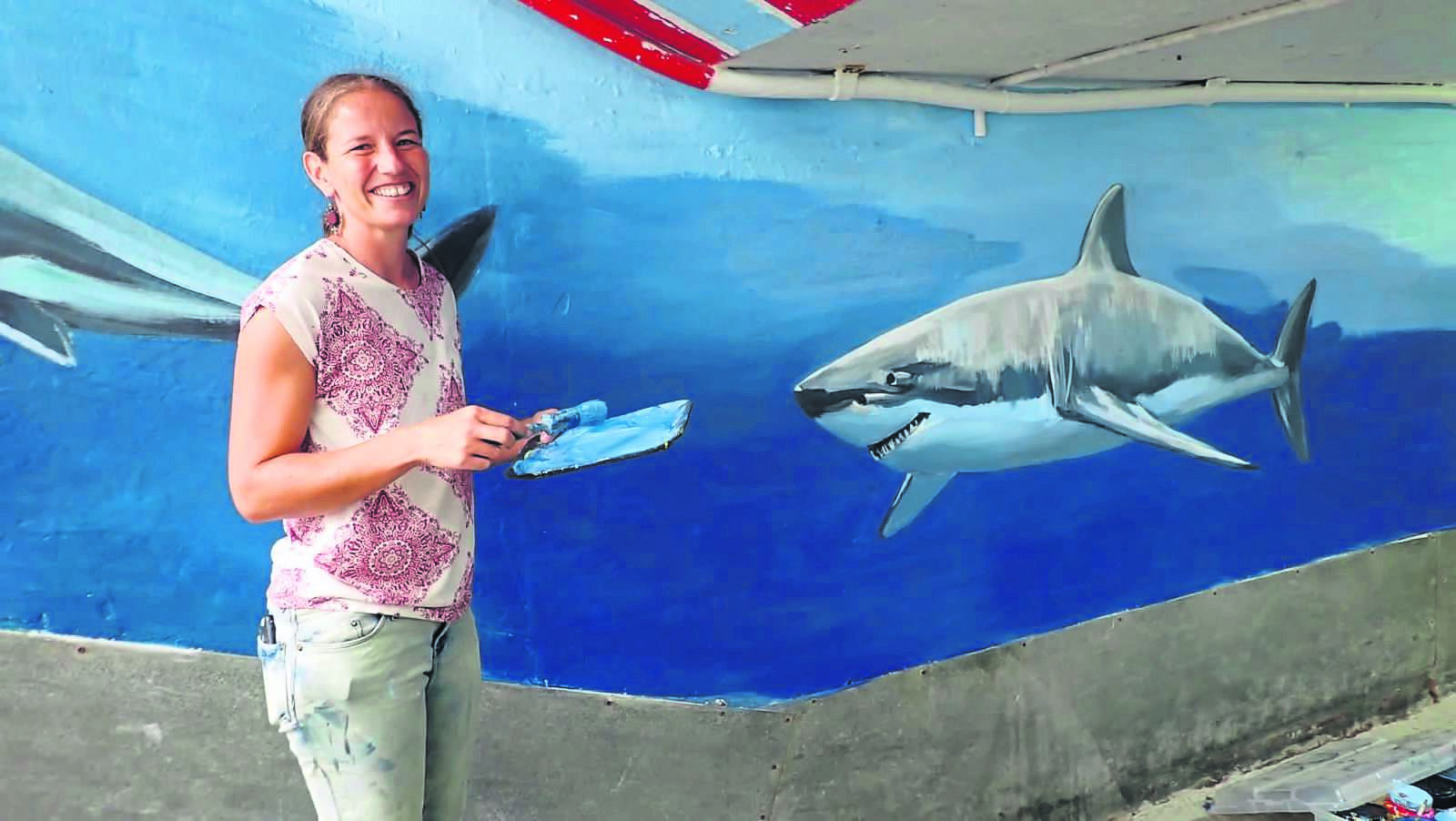 Local artist Christine Andrews is bringing sea creatures to life in her murals painted in the subway near the Brass Bell. 