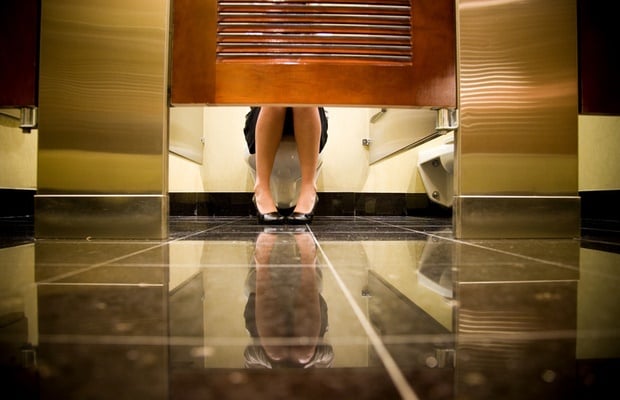 woman in bathroom stall 