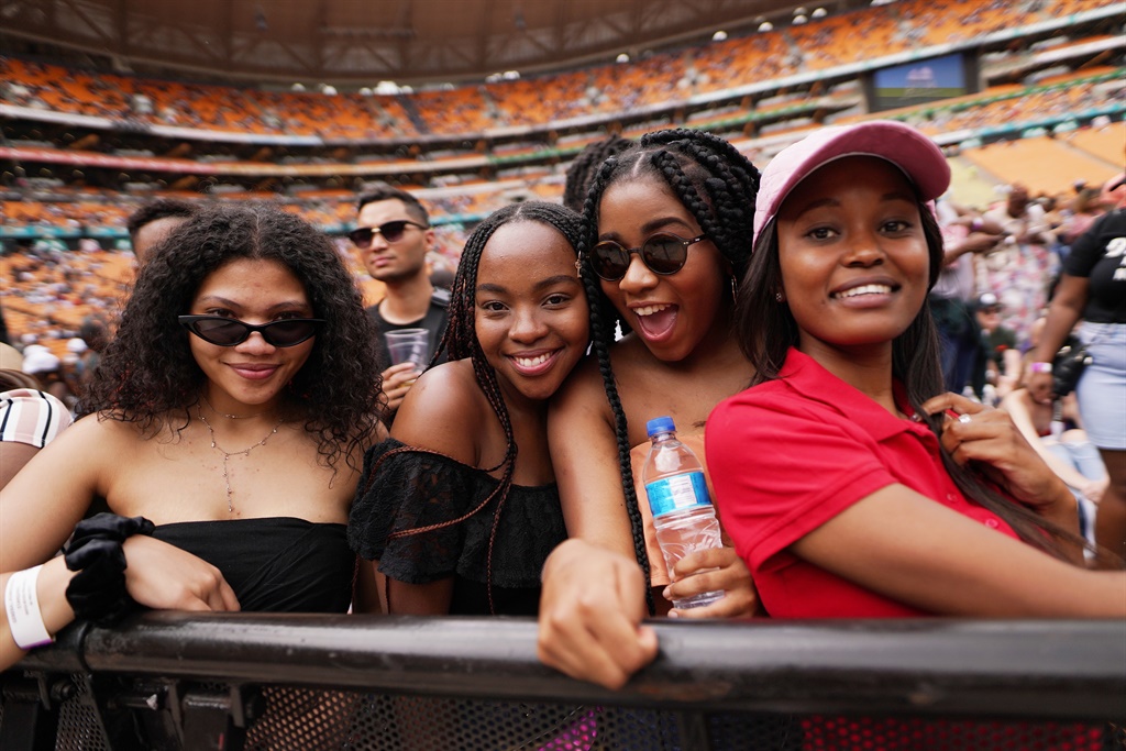 Guests pose in the audience during the Global Citizen Festival: Mandela 100 at FNB Stadium, Johannesburg