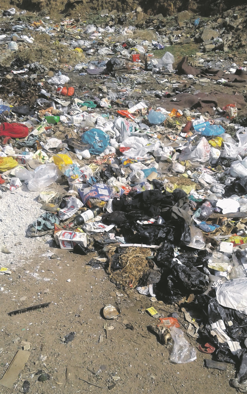 Rubbish used to pile up next to the gogo’s house before residents cleaned up the mess.     Photo by Lucas Mabunda