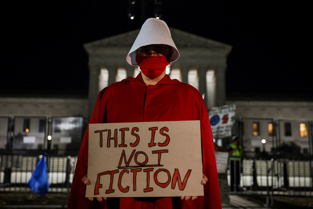 An abortion rights demonstrator dressed in a Handm