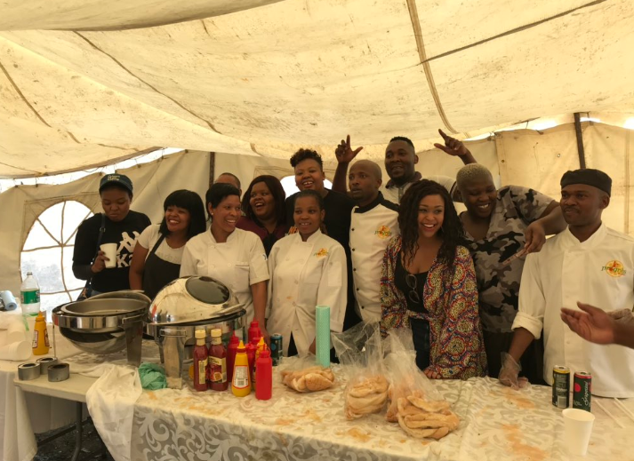 Anele Mdoda, Minnie Dlamini and Celeste Ntuli serve food to the community of Alex.