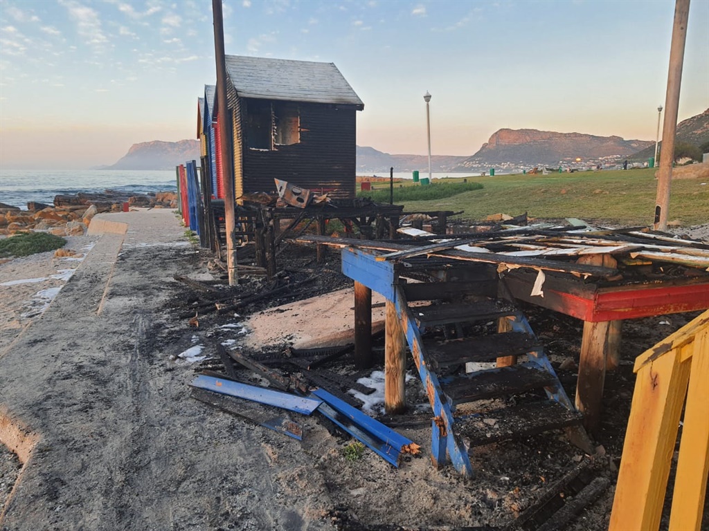 Three of the iconic bathing boxes at St James Beach have been gutted in a fire.