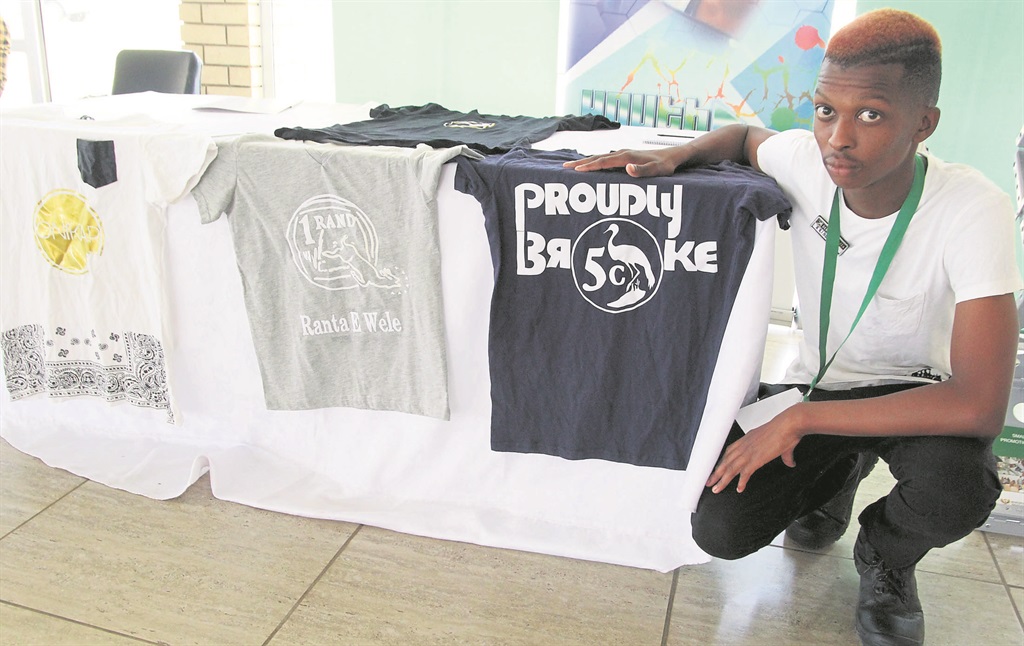 Tumelo Thulo shows some of his products.   Photo by Dan Xangaza