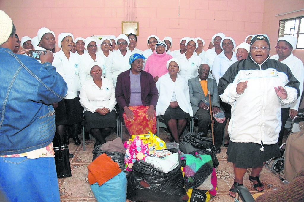 Members of Edward Memorial Congregational Church donated gifts to Ekuphumleni Old Age Home in Zwide.   Photo by Chris Qwazi.