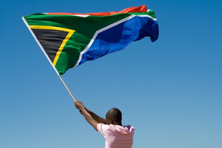 A man waves the South African flag with pride. The DA recently showed the flag burning in one of its campaign ads. (Photo: iStock)