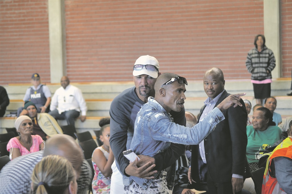 Police remove Julian Julies after he was ordered out of the hall.              Photos by Luvuyo Mehlwana