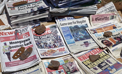 <p>Newspapers are held down by rocks to stop them blowing away
at a news stand in Harare, Zimbabwe. 

&nbsp;

</p><p>Long-time President Robert Mugabe ignored a 12:00 deadline
set by the ruling party to step down or face impeachment proceedings, while Zimbabweans
stunned by his lack of resignation during a national address vowed more
protests to make him leave. (Ben Curtis, AP)

</p>