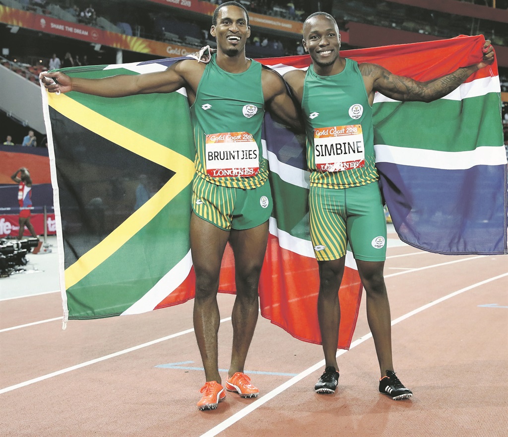 HISTORIC MOMENT Runner-up Henricho Bruintjies and champion Akani Simbine are all smiles after leading South Africa to a 100m one and two during the Commonwealth Games. Picture: Cameron Spencer / Getty Images