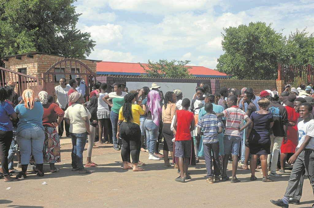 Angry parents outside Zamokhanyo Primary School want the alleged rapists handed over to them.              Photo by Phineas Khoza
