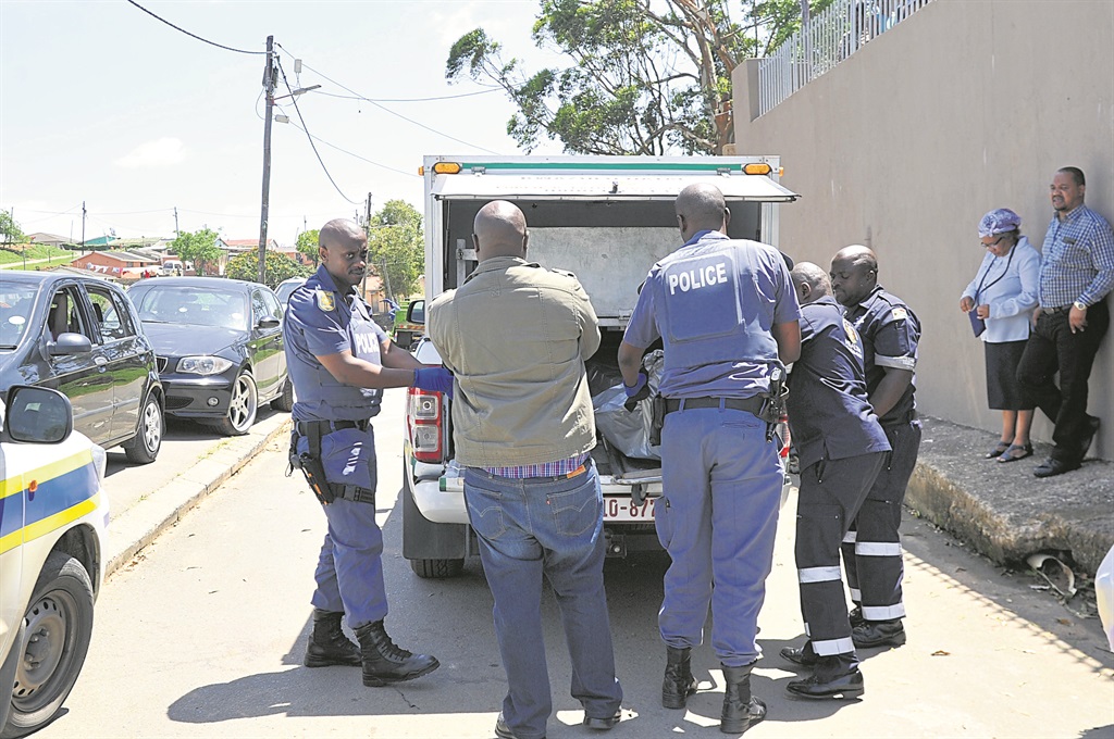 Police loaded the body of Mthobisi Ngcobo into a mortuary van after he committed suicide.                       Photo by Jabulani Langa