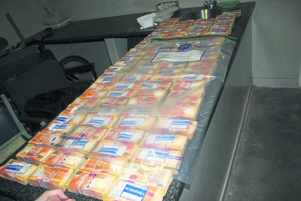Police seized R400 000 in cash from a man who has been charged with money-laundering.