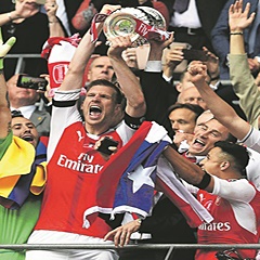 FLASHBACK:  Arsenal captain Per Mertesacker lifts the FA Cup trophy after they beat Chelsea in the final last year. They now face Nottingham Forest in the fourth round. (Facundo Arrizabalaga, EPA)