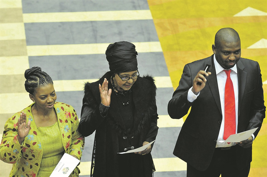 ANC stalwart Winnie Madikizela-Mandela, flanked by Nomaindia Mfeketo and Buti Manamela, taking the Oath of Office during the swearing in of members of Parliament in 2014 Picture: GCIS