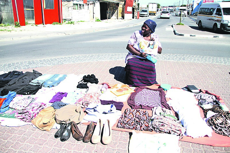Mama Nonkosi Cubeka makes a living by selling clothes and tea bags in Mfuleni kasi.                        Photo by Lindile Mbontsi