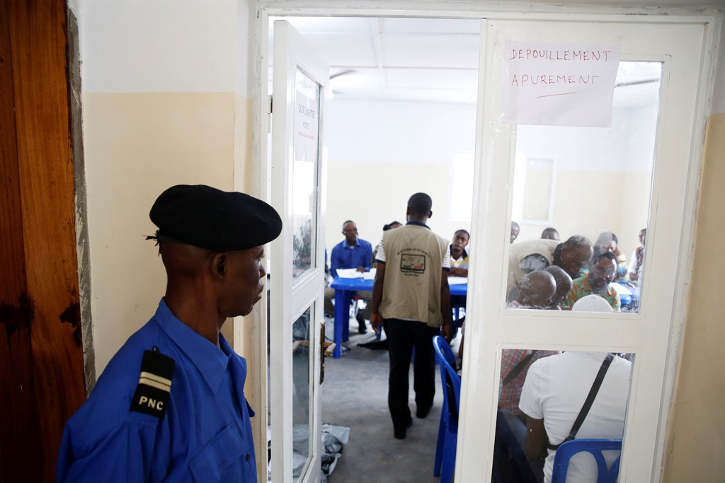 A Congolese policeman guards a room where officials of Congo’s Independent National Electoral Commission (Ceni) count presidential elections ballots at a tallying centre in Kinshasa. Picture: Baz Ratner/Reuters