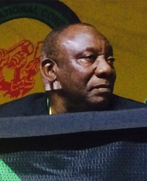 Ramaphosa sits on stage waiting to address delegates.<br />