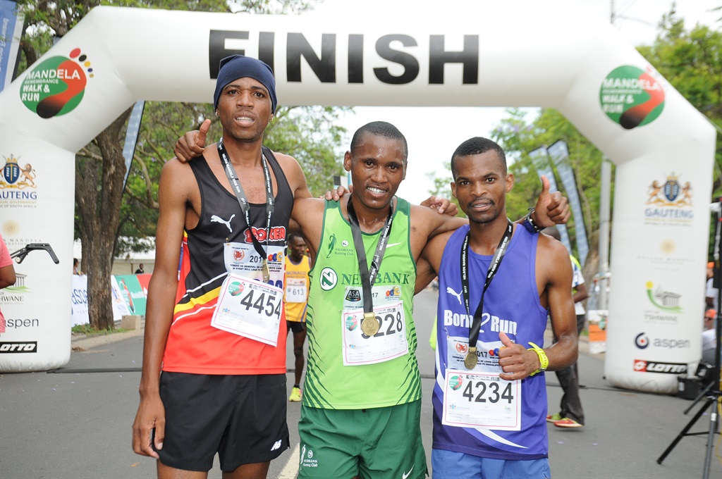 The winners of the Mandela Remembrance Walk and Run: Lucky Mohale (second ), Sibusisi Nzima (first) and Reghen Magwai (third). Picture: Silver Sibiya