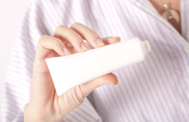 Woman holding tube of ointment 