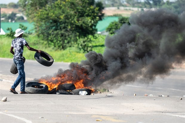 A protester burns tyres on a road during a
"stay-away" demonstration against the doubling of fuel prices in
Emakhandeni township, Bulawayo. (Picture: AFP)

