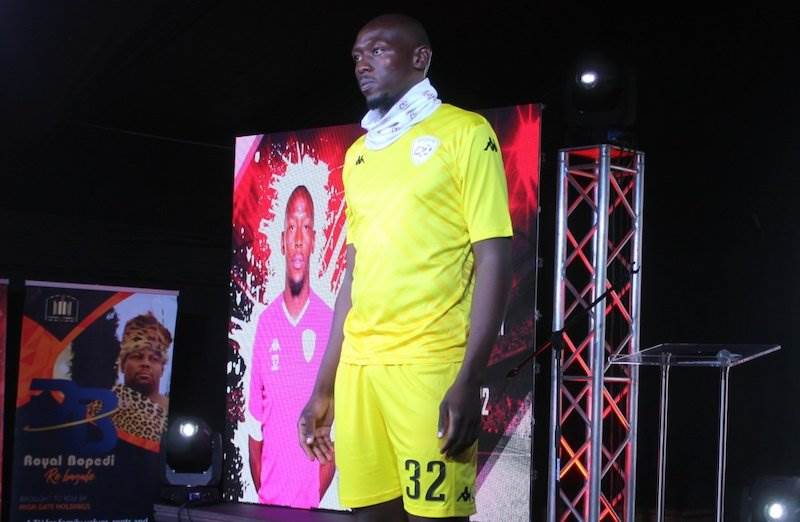 McClive Phiri shows off a new yellow strip