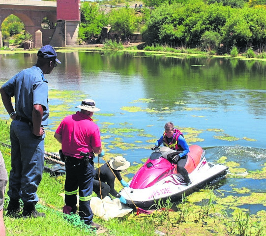 Divers remove the bodies of the two men who drowned.  