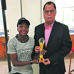 VICTORIOUS:   CAF nominee Thembi Kgatlana and SA Football Association head Danny Jordaan hold the CAF women’s national team of the year award won by Banyana Banyana. (Supplied)