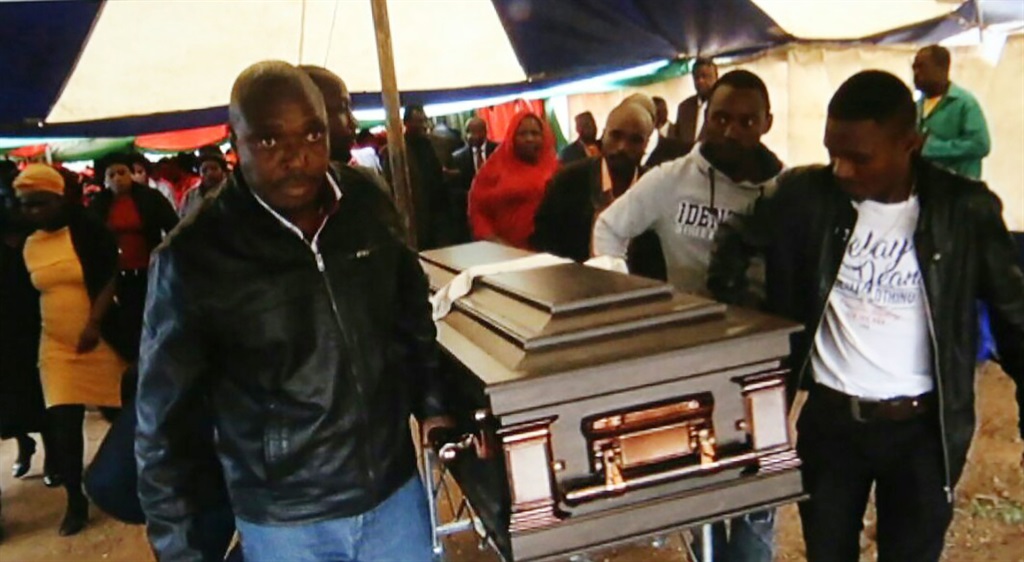 Pallbearers carrying a coffin of Aron Mutavhatsindi to his final resting place. 