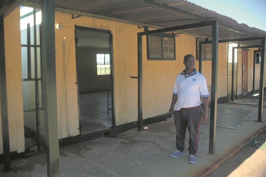 Vusi Dlamini inspects damage at Vezukhono Secondary.                  Photo by Phineas Khoza