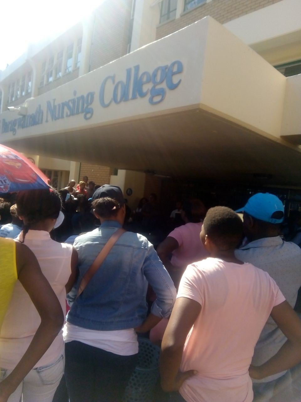 Students wait outside Chris Hani Baragwanath Nursing College on Monday.