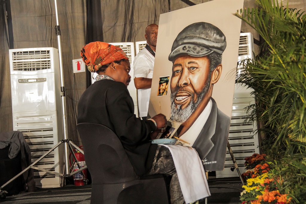 An artist paints a portrait of the late Keorapetse William Kgositsile at his memorial service. Picture: Mpumelelo Buthelezi 