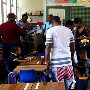 A grade 1 class packed with parents setting up required classroom tools for their children starting primary school for the first time. 