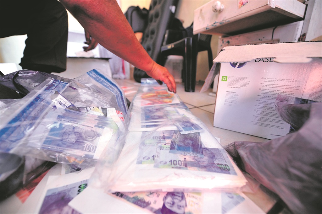 Cops seized fong kong bank notes in Elandspark yesterday.                           Photo by Christopher Moagi