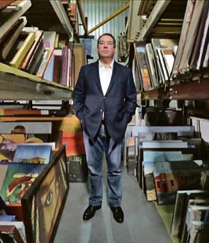 Ivor Ichikowitz stands among thousands of artworks collected over the decades