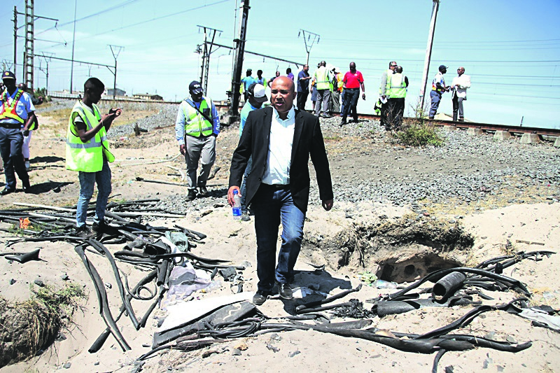 Metrorail regional manager Richard Walker inspects the damage at Netreg station.               Photo by Lindile Mbontsi