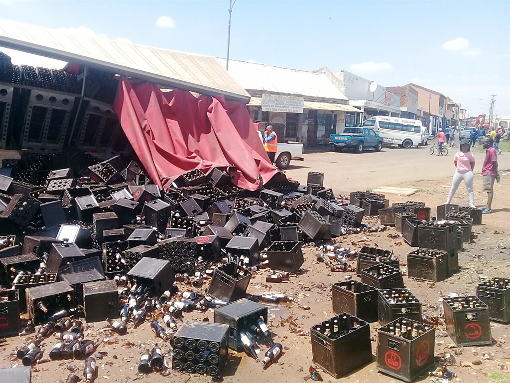 The scene at Gugulethu Everest squatter camp yesterday after a beer truck overturned and lost its load. 