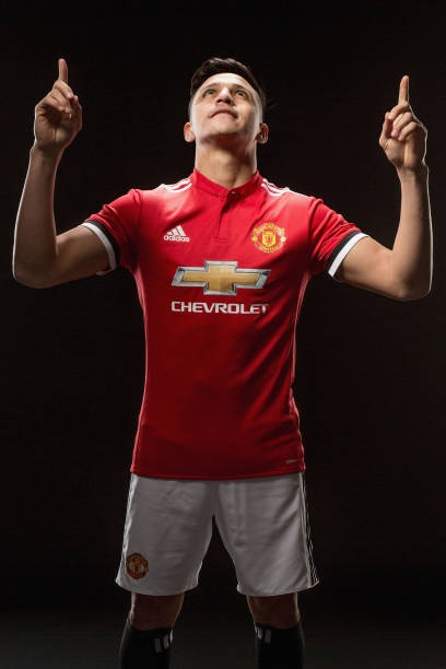 Alexis Sanchez of Manchester United poses after signing for the club at Old Trafford