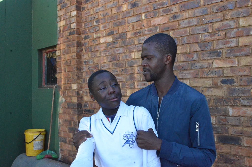 Tisetso Motseke is comforted by Musawonke Luvuno. 