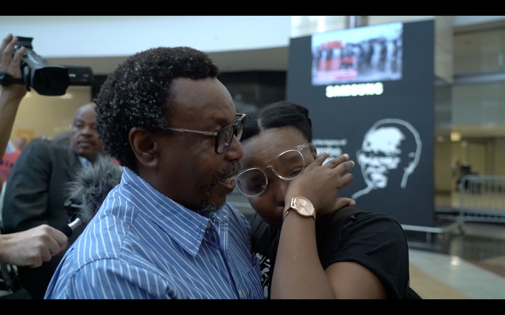 A father embraces his daughter after her safe return to South Africa from war-torn Sudan.