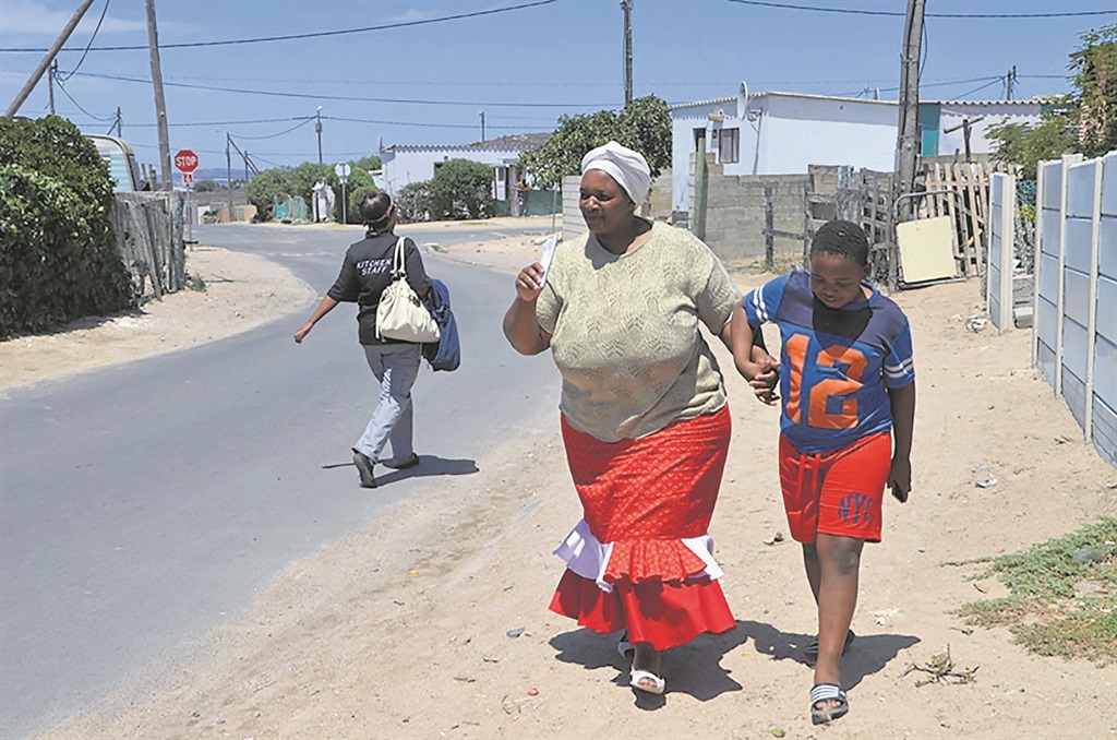Ntombi Ndzimeni resents having to walk her son Awonke to the bus stop every morning. Photo by Lulekwa Mbadamane