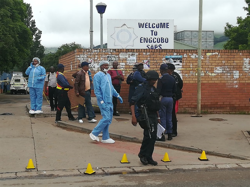 Investigatores and forensic teams check out the scene at Ngcobo police station. Picture: LUBABALO NGCUKANA