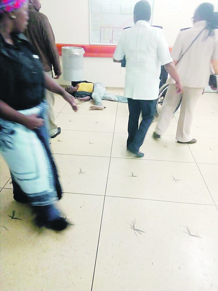 Nurses at Dora Nginza Hospital in Port Elizabeth walk past the struggling patient on the floor.  Photo from Facebook