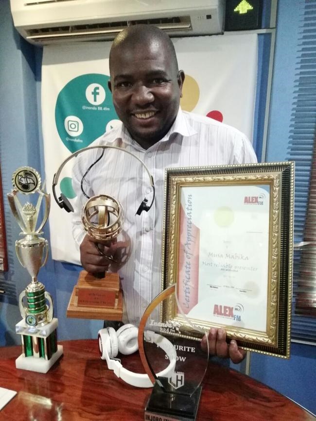 DJ Ghetto with the awards he’s won  at different radio stations over the years.