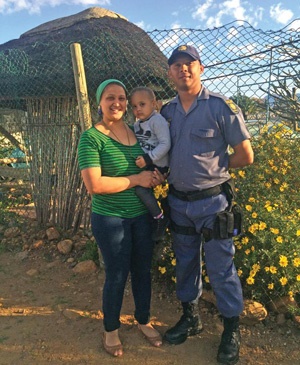 Constable Laeeq Engelbrecht with his wife, Wesaal, and their daughter, Aneeqah, outside their home. Picture: BIÉNNE HUISMAN
